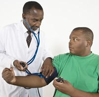 Doctor taking patient's blood pressure
